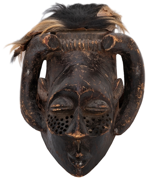  [African] Kuba-Style Mask. A wooden mask with horn-like fea...
