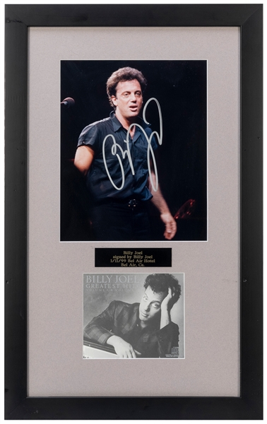  Billy Joel Photo Display. 1999. Photograph signed in silver...