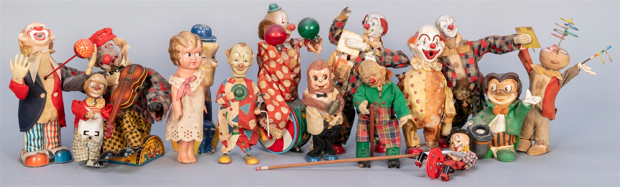  Group of Tin Clown Toys. Thirteen clown toys, primarily tin...
