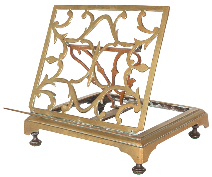  Adjustable brass book stand with ornate design. Circa 1880s...