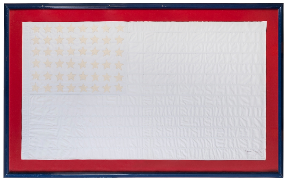 MOSCONI, Roger P. (American). White American Flag. 1965. Sewn cloth. Signed on lower right corner. 31 ¾ x 57”.  Mounted, framed and glazed (frame size: 41 x 65 ½”). Some wear, holes in frame (holes...