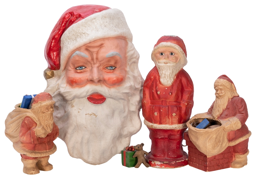  Group of 4 papier-mache Santa Claus figurines, including a ...