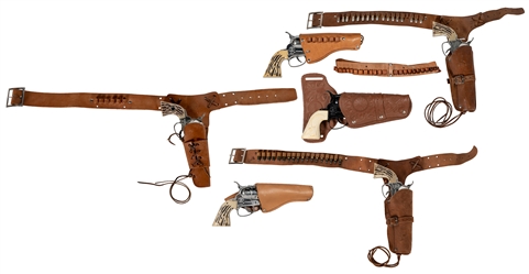  Group of 4 Fanner 50 cowhide holsters and belts with guns, ...