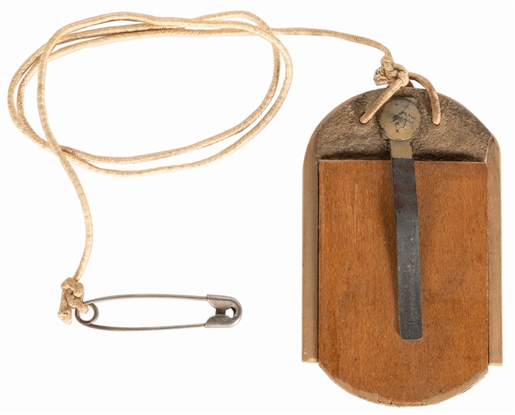  Drop Bug Holdout. A dog-tag shaped wooden holdout that hang...