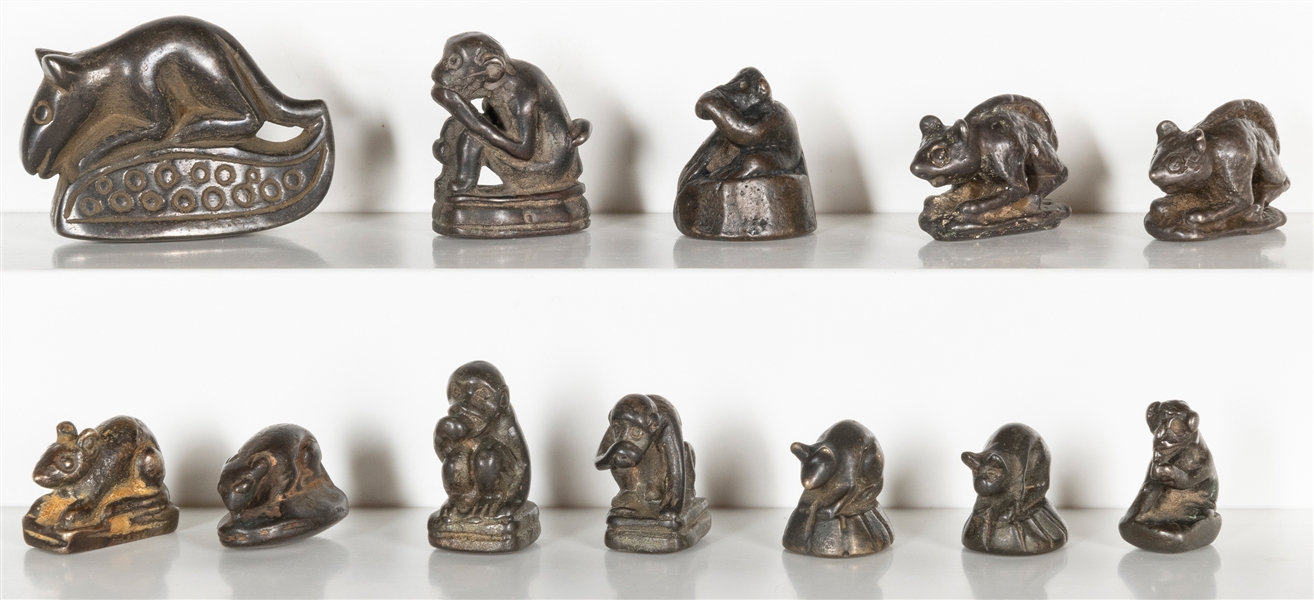  A group of 12 graduated metal monkey and mouse opium weight...