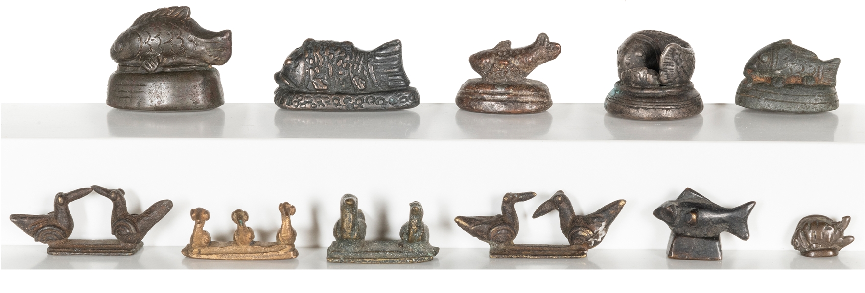  A group of 11 graduated metal fish and bird opium weights. ...