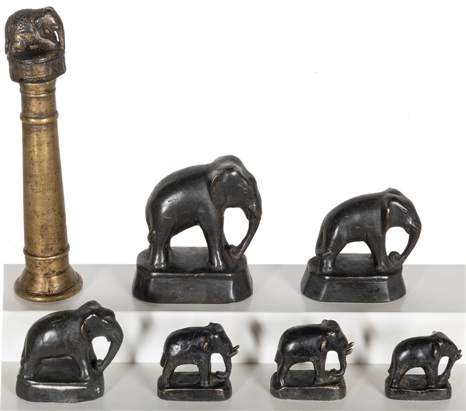  A group of six metal elephant opium weights, and an elephan...