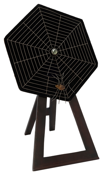  Card Spider. 1960s. A spider’s web sitting on a wooden ease...