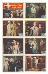  [CHARLIE CHAN]. Dark Alibi. Group of Eight Color Lobby Card...