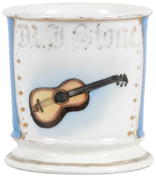  Guitar Shaving Mug. Gilt painted porcelain, lettered M.J. S...