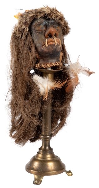 Gaff Shrunken Head. 20th century. Gaff shrunken head on bra...